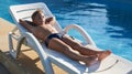 Cute boy taking sun near a swimming pool Royalty Free Stock Photo