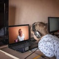 Cute boy talking with his grandmother within video chat on laptop, life in quarantine time Royalty Free Stock Photo