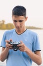 Cute boy teenager with vintage rangefinder camera.