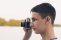 Cute boy teenager with vintage rangefinder camera.