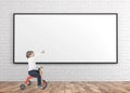 Cute boy on a tricycle, showing finger whiteboard Royalty Free Stock Photo