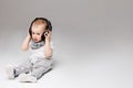 Cute boy two years old listening music in earphones. Royalty Free Stock Photo
