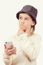 Cute boy using a smart phone over white background. Smart kid holding a mobile phone. Technology, lifestyle and people concept Royalty Free Stock Photo