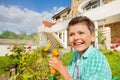 Cute boy watering garden with hand sprinkler Royalty Free Stock Photo