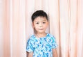 Cute boy wear flower shirt on pink curtain background