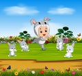 The cute boy wearing the rabbit costume and play with rabbits