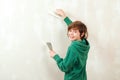 Cute boy working with spatula. Home renovation. Cute son helps parents to repair room. Kid with tools Royalty Free Stock Photo