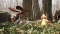 A cute brave elf fights with a magic elven sword with a terrible dangerous flying insect in a summer magic forest. Magic