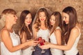 Cute bride and happy bridesmaids celebrating hen-party with red champagne Royalty Free Stock Photo