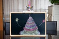 A cute british shorthair cat behind a blackboard with birthday cake celebrating her 1-year-old birthday Royalty Free Stock Photo