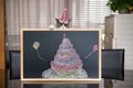 a cute british shorthair cat behind a blackboard with birthday cake celebrating her 1-year-old birthday Royalty Free Stock Photo