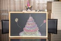 a cute british shorthair cat behind a blackboard with birthday cake celebrating her 1-year-old birthday Royalty Free Stock Photo