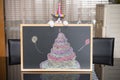 A cute british shorthair cat behind a blackboard with birthday cake celebrating her 1-year-old birthday Royalty Free Stock Photo