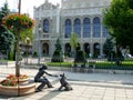 Cute bronze statue of girl playing with her dog Royalty Free Stock Photo