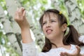 Cute brunette girl holds found larva Royalty Free Stock Photo