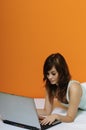 Cute brunette girl using laptop in bed Royalty Free Stock Photo