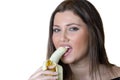 Cute brunette lady, eating a peeled banana Royalty Free Stock Photo