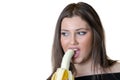 Cute brunette lady, eating a peeled banana Royalty Free Stock Photo