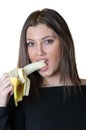 Cute brunette lady, eating a peeled banana Royalty Free Stock Photo