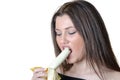 Cute brunette lady, eating a peeled banana Royalty Free Stock Photo