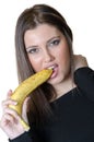 Cute brunette lady wear black shirt, holding and biting a banana Royalty Free Stock Photo