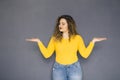 Cute brunette plus size woman with curly hair in yellow sweater Royalty Free Stock Photo