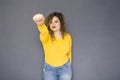 Cute brunette plus size woman with curly hair in yellow sweater Royalty Free Stock Photo