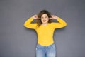 Cute brunette plus size woman with curly hair in yellow sweater Royalty Free Stock Photo