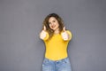 Cute brunette plus size woman with curly hair in yellow sweater Royalty Free Stock Photo