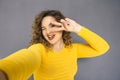 Cute brunette plus size woman with curly hair in yellow sweater Royalty Free Stock Photo