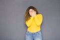 Cute brunette plus size woman with curly hair in yellow sweater Royalty Free Stock Photo