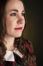 Cute brunette in tartan dress with red lips and curles. Studio portrait Royalty Free Stock Photo
