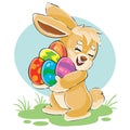 Cute bunny holds in its paws a lot of Easter eggs painted in different colors,