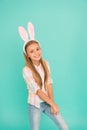 Cute bunny. Holiday bunny girl posing with cute long ears. Child smiling play bunny role. Happy childhood. Traditions