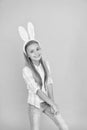 Cute bunny. Holiday bunny girl posing with cute long ears. Child smiling play bunny role. Happy childhood. Traditions