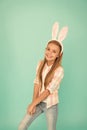 Cute bunny. Holiday bunny girl posing with cute long ears. Child smiling play bunny role. Happy childhood. Traditions