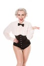 Cute burlesque dancer in bow tie, frilled shirt & corset, isolated on white Royalty Free Stock Photo