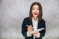 Cute business women standing listening attentively, ready to write down something important into notebook. Royalty Free Stock Photo