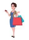 Cheerful young business woman holding credit card and shopping bags