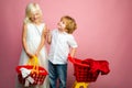 Cute buyer customer client hold shopping cart. Buy with discount. Girl and boy children shopping. Couple kids hold Royalty Free Stock Photo