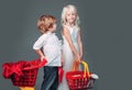 Cute buyer customer client hold shopping cart. Girl and boy children shopping. Couple kids hold plastic shopping basket Royalty Free Stock Photo