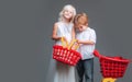 Cute buyer customer client hold shopping cart. Girl and boy children shopping. Kids store. Couple kids hold plastic Royalty Free Stock Photo