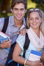 Cute campus couple. Portrait of two young students standing outside on campus. Royalty Free Stock Photo