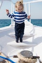 Cute and carefree. Adventure boy sailor travelling sea. Child cute sailor on yacht sunny day. Boy adorable sailor