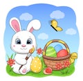 A cute cartoon Easter bunny paints Easter eggs and puts them in a basket. Royalty Free Stock Photo