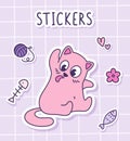 Cute Cartoon funny cat licking his fur. Sticker of a pink cat with toys on a checkered background. Label Sticker.