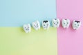 Cute cartoon healthy and decayed teeth icon on pastel backdrop