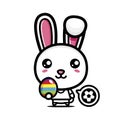 Cute cartoon rabbit character becomes a soccer player holding easter egg on easter day Royalty Free Stock Photo