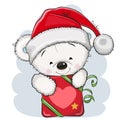 Cute Cartoon Teddy Bear in a Santa hat with gift Royalty Free Stock Photo