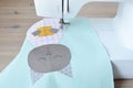 Cute cat applique working process: sewing machine and applique pieces on desk Royalty Free Stock Photo